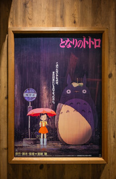 tokyo, odaiba - may 22 2025: Japanese movie poster of My Neighbor Totoro directed by Hayao Miyazaki in 1988 showing Satsuki waiting at a rainy bus stop for the Catbus, evoking nostalgia and magic.