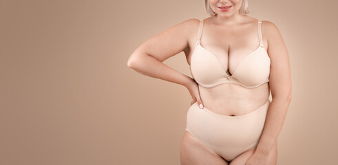Self Acceptance. Beautiful Curvy Lady In Underwear Posing On Beige Background In Studio, Body...