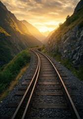 Fototapeta premium Railway track leading to sunset in mountain valley