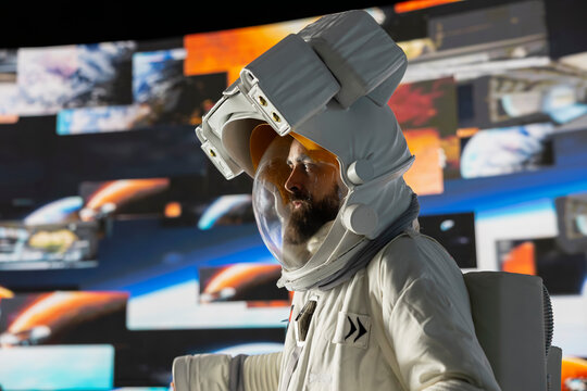 Curious astronaut standing on a distant planet in space suit and helmet, collecting a soil sample beneath a vast sky filled with stars. Exploring alien worlds and cosmic frontiers in a space craft.