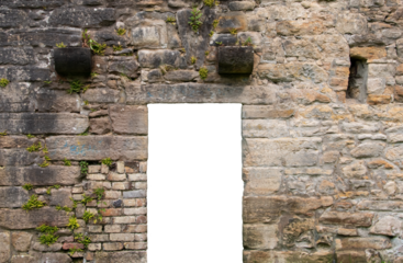 A doorway with a transparent background in an old brick and stone wall in the ruins of a mill, with some plants growing out of the wall.
