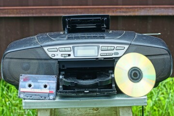one old plastic portable with antenna stereo with speakers black with buttons and handle electric...