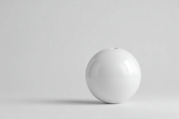 minimalist bowling scene featuring single bowling ball in focus set against light gray background