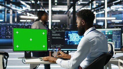Data center admin using AI node tree software on isolated screen PC to minimize system downtime. Server hub worker uses artificial intelligence visual programming tool on chroma key computer, camera B