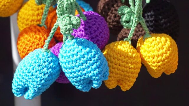 Keychain crafts made from knitting yarn hanging on display