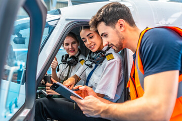 Maintenance engineer briefing pilots showing thumbs up inside cockpit © unai