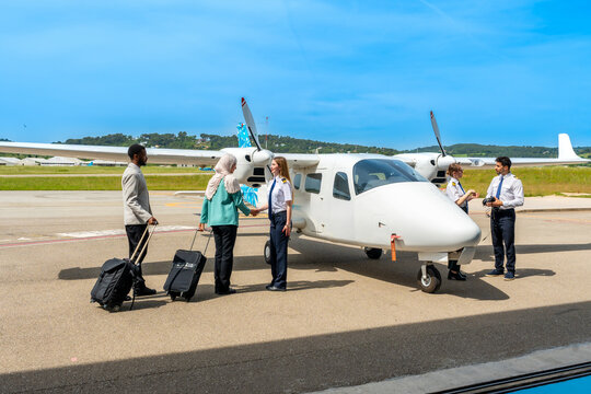 Passengers shaking hands with pilot before boarding private plane