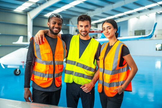 Aircraft maintenance crew smiling together in hangar