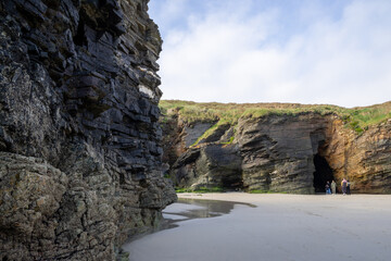 Stunning rock arches and caves at Playa de las Catedrales (Beach of the Cathedrals), Ribadeo, Lugo, Galicia, Spain, visible only at low tide. Unique coastal landscape for nature lovers.
