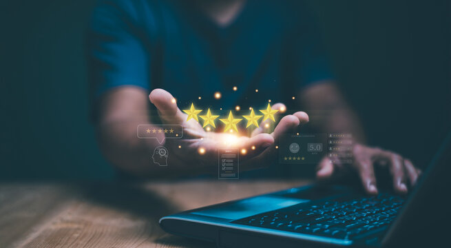 Customer satisfaction concept. Hand holding golden five stars for excellent evaluate of product or service by use AI technology. Innovative leveraging AI to elevate customer service standard.