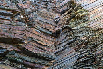 Iconic natural rock formations of Playa de las Catedrales beach in Ribadeo, Lugo, Galicia, Spain, captured during low tide. A breathtaking seascape with caves and arches.