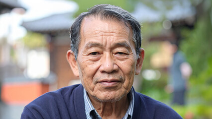 Fototapeta premium A dignified elderly man gazes thoughtfully into the camera, his expression conveying experience and wisdom