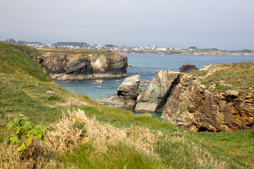 Praia de Augasantas Playa (Beach of the Cathedrals) with majestic cliffs and arches carved by the...