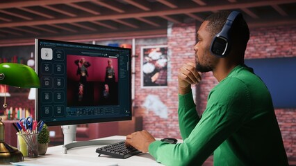 Black graphic designer working in loft with AI image generator software. Digital screen displaying visuals created through machine learning and cloud computing, generative AI. Camera B.