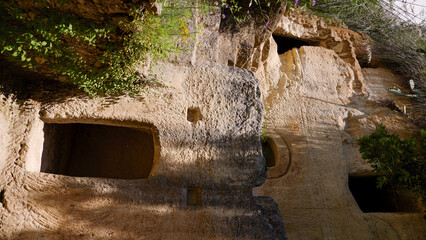 Sunlight illuminating the rock cut tombs in the rupestrian settlement of Zungri, a captivating...