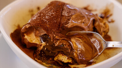 Spoon taking a scoop of delicious chocolate Tartufo ice cream dessert from Pizzo, Calabria, Italy