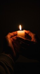 Tender Hands Protecting a Flickering Candlelight in the Dark