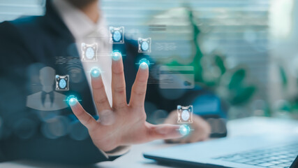 A businessman using a biometric fingerprint scan for digital identity verification on a futuristic interface, symbolizing cybersecurity, access control, and modern digital authentication technology.