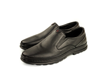 Elegant black leather classic summer shoes with perforated trim on clean white background