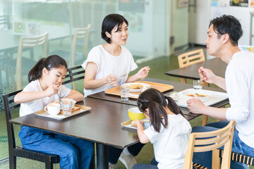 飲食店で食事する家族