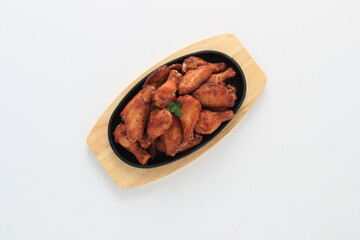 Korean-style fried chicken wings and drumsticks served in a skillet. Crispy texture with sweet and spicy glaze. A popular K-Food dish enjoyed at home and in restaurants.
