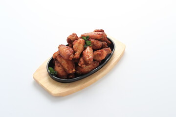 Korean-style fried chicken wings and drumsticks served in a skillet. Crispy texture with sweet and spicy glaze. A popular K-Food dish enjoyed at home and in restaurants.

