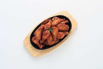 Korean-style fried chicken wings and drumsticks served in a skillet. Crispy texture with sweet and spicy glaze. A popular K-Food dish enjoyed at home and in restaurants.
