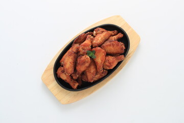 Korean-style fried chicken wings and drumsticks served in a skillet. Crispy texture with sweet and spicy glaze. A popular K-Food dish enjoyed at home and in restaurants.
