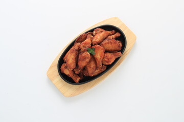 Korean-style fried chicken wings and drumsticks served in a skillet. Crispy texture with sweet and spicy glaze. A popular K-Food dish enjoyed at home and in restaurants.
