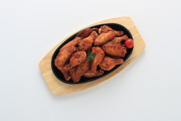 Korean-style fried chicken wings and drumsticks served in a skillet. Crispy texture with sweet and spicy glaze. A popular K-Food dish enjoyed at home and in restaurants.
