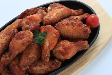 Korean-style fried chicken wings and drumsticks served in a skillet. Crispy texture with sweet and spicy glaze. A popular K-Food dish enjoyed at home and in restaurants.
