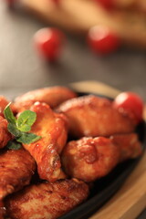 Korean-style fried chicken wings and drumsticks served in a skillet. Crispy texture with sweet and spicy glaze. A popular K-Food dish enjoyed at home and in restaurants.
