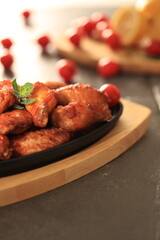 Korean-style fried chicken wings and drumsticks served in a skillet. Crispy texture with sweet and spicy glaze. A popular K-Food dish enjoyed at home and in restaurants.
