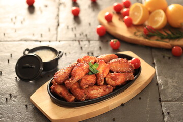 Korean-style fried chicken wings and drumsticks served in a skillet. Crispy texture with sweet and spicy glaze. A popular K-Food dish enjoyed at home and in restaurants.
