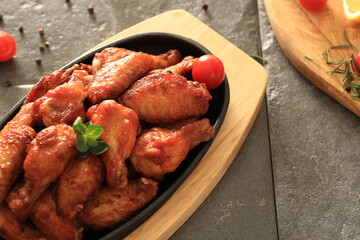 Korean-style fried chicken wings and drumsticks served in a skillet. Crispy texture with sweet and spicy glaze. A popular K-Food dish enjoyed at home and in restaurants.
