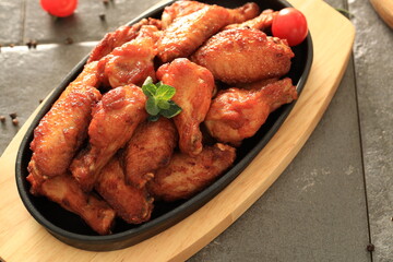 Korean-style fried chicken wings and drumsticks served in a skillet. Crispy texture with sweet and spicy glaze. A popular K-Food dish enjoyed at home and in restaurants.

