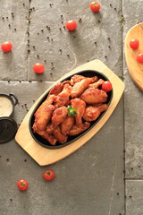Korean-style fried chicken wings and drumsticks served in a skillet. Crispy texture with sweet and spicy glaze. A popular K-Food dish enjoyed at home and in restaurants.
