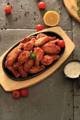 Korean-style fried chicken wings and drumsticks served in a skillet. Crispy texture with sweet and spicy glaze. A popular K-Food dish enjoyed at home and in restaurants.
