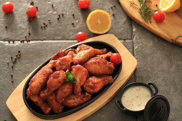 Korean-style fried chicken wings and drumsticks served in a skillet. Crispy texture with sweet and spicy glaze. A popular K-Food dish enjoyed at home and in restaurants.
