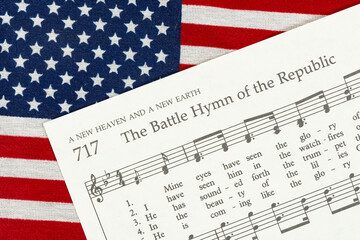 The Battle Hymn of the Republic sheet music on top of an American Flag