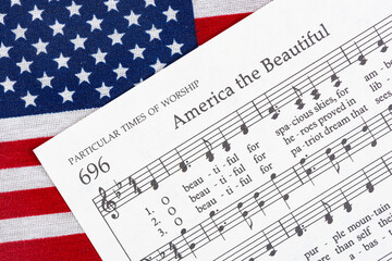 The America the Beautiful sheet music on top of an American Flag