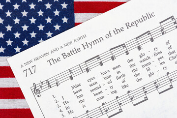 The Battle Hymn of the Republic sheet music on top of an American Flag