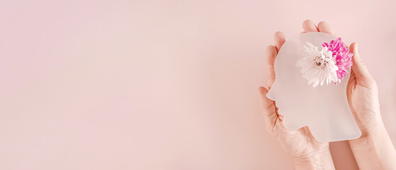 Hands holding model brain with flowers, positive mental health, mindfulness, wellness, self care...
