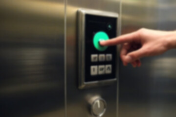 Fototapeta premium blurry image Pressing the button in the elevator