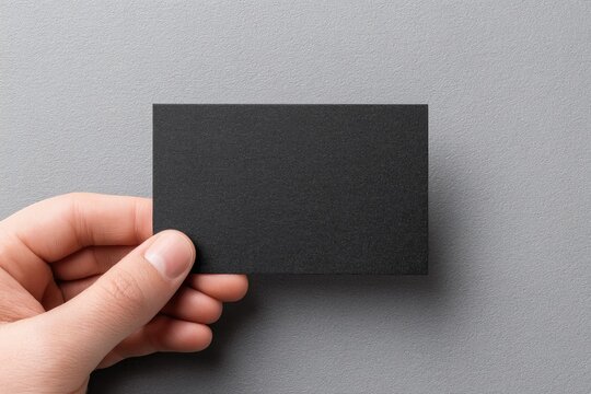 Hand holding blank black card - Powered by Adobe
