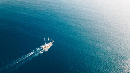Minimal Aerial View of a Sailing Boat on the Blue Sea