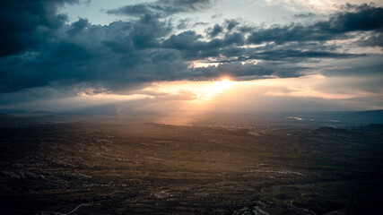 Aerial Panorama of Cappadocia at Sunset with Sunbeams Through Clouds