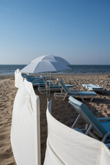 Fototapeta premium White sandy beach in cosy seaside holiday village on North Sea, built in belle epoque style in Flanders, De Haan or Le Coq sur Mer, Belgium