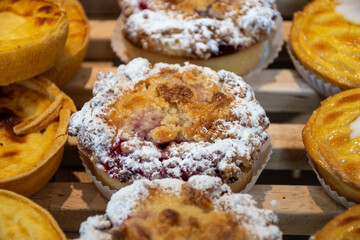 Fresh baked buttered fruit and sweet buns, cakes, pastries in artisan bakery early morning in Bruges, Belgium