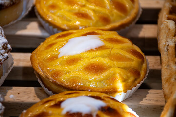 Fresh baked buttered fruit and sweet buns, cakes, pastries in artisan bakery early morning in Bruges, Belgium